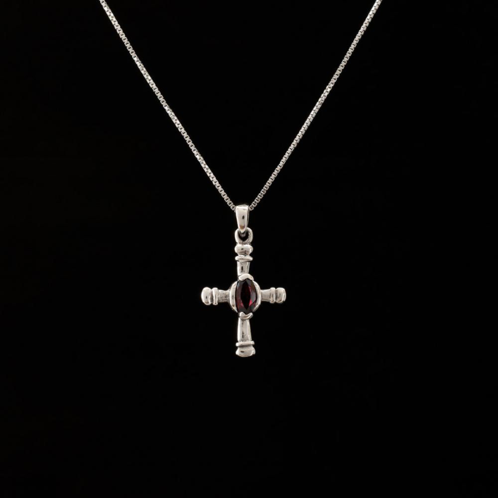 Silver cross with garnet stone