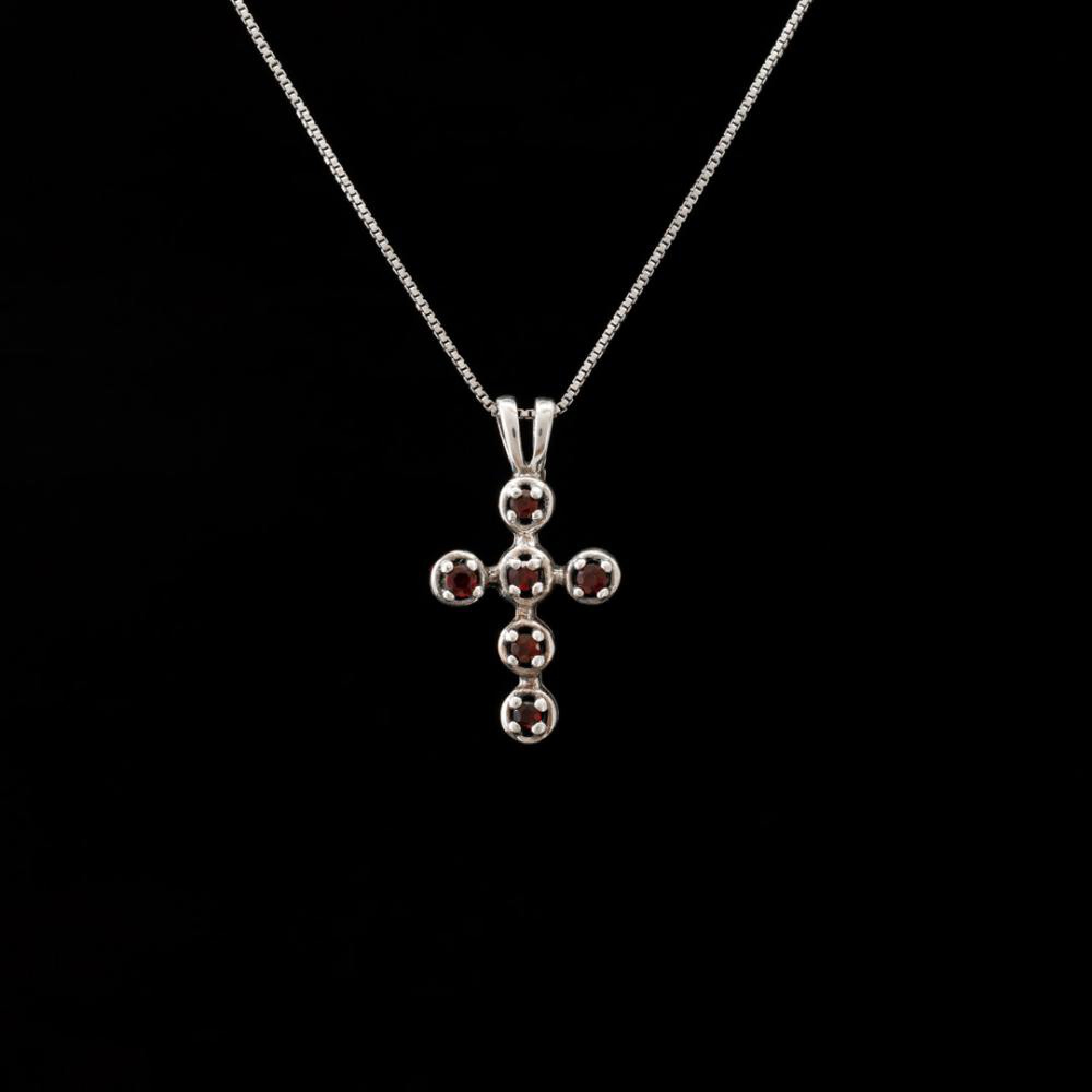 Silver cross with garnet stones